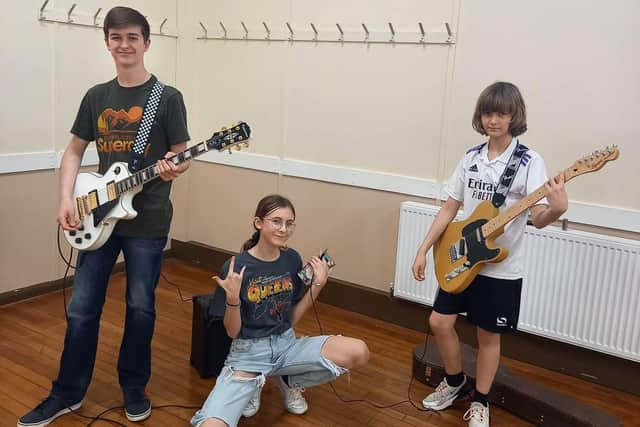 Three festival attendees learning music at a festival event run
by Thorne Arts Network at St Nicholas Church Hall in Thorne