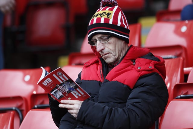 An early-bird Blade takes in the matchday programme before the game