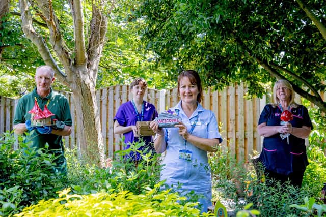 In the Fairy Garden at St John's Hospice: Hospice Nursing Assistant Michelle Hannan, is pictured with some of the garden’s attractions and L-R Grounds and Gardens Supervisor Alan Pakeman, Rachel Horne and Linda Rowe.