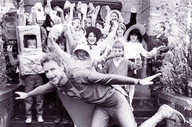 Woodthorpe Nursery, First and Middle Community School headteacher Dave Sandilands dressed as Superman, being much enjoyed by the dressed-up pupils, in 1989