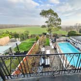 View over the swimming pool and garden from the balcony of the semi-detached home.