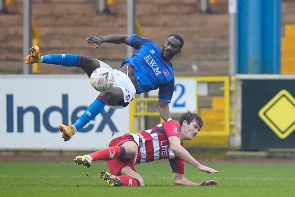 Joe Wright slide to win the ball from Carlisle's Gime Toure. Picture: Steve Flynn/AHPIX