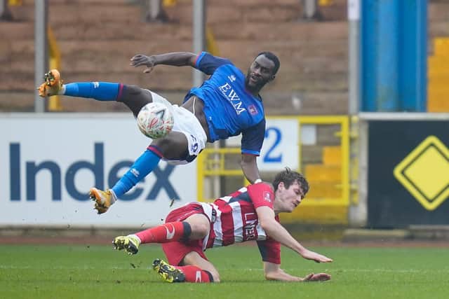 Joe Wright slide to win the ball from Carlisle's Gime Toure. Picture: Steve Flynn/AHPIX