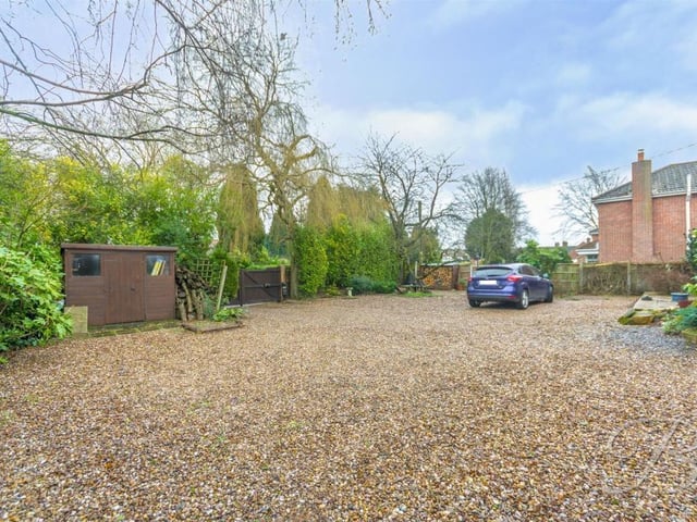 We sign off with this photo of the gravelled driveway. As you can see, it is larger than average, giving off-street parking space for multiple vehicles.
