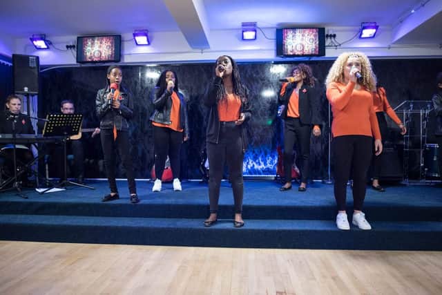 Young adults singing at the group.