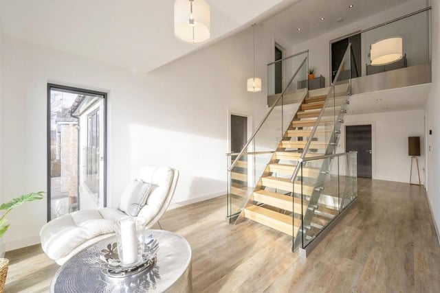 The oak and glass gallery staircase is a feature within the property.