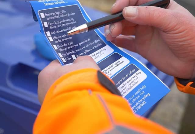 The blue tags that will be placed on recycling bins where the wrong items have been disposed of