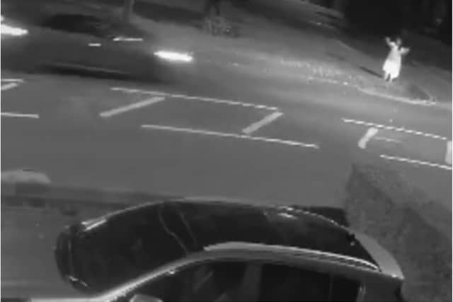 The woman, barefoot and dressed only in a gown,  was captured on CCTV attempting to flag down a car near to the hospital.