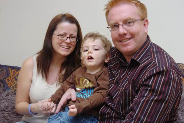 Two-tear-old Lewis Jeynes has been struck with a mystery illness which has left him unable to walk or talk. He is pictured with mum Samantha, and Dad James (Picture: Liz Robinson D9166LR)