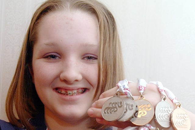 Charlotte Henshaw with her swimming medals, pictured in 2002.
These were just a handful of the medal haul she attained over a successful para-swimming career.
