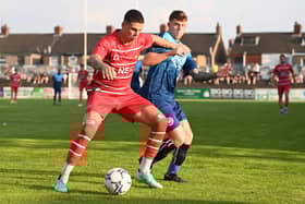 Tiago Cukur holds off a challenge on his first appearance in Rovers colours at Wakefield. Picture: Howard Roe/AHPIX