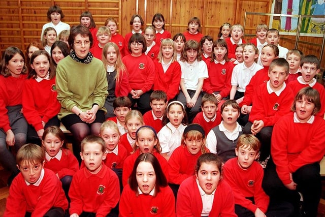 Proud teacher Ann Chivers and the fifty Barnby Dun Primary School pupils who were chosen to sing carols at Sheffield Arena, December 1998