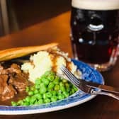 Meat pie with mash and peas.
