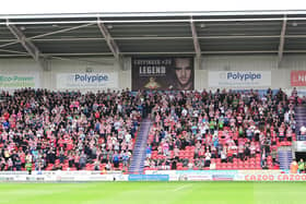 Doncaster Rovers fans pay their respects to former manager Sammy Chung with a minute's applause against Mansfield Town.