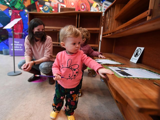 Young Olivia Doolan in the Studio in front of the Adrian Wiszniewski murals.