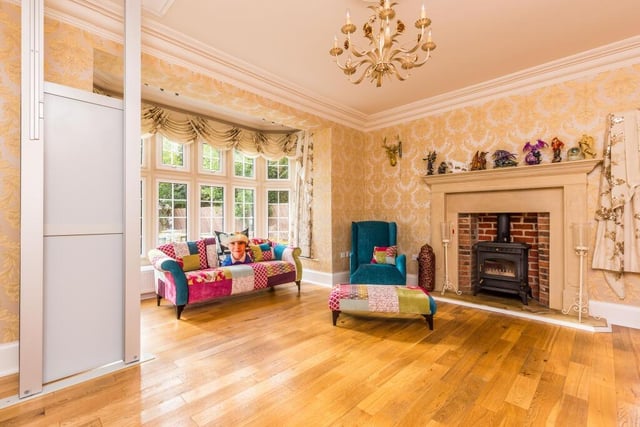 A lovely reception room with bay window and striking fireplace.