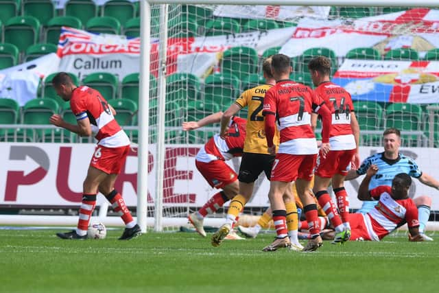 Doncaster Rovers' Joseph Olowu clearance rebounds of skipper Richard Wood for Newport's third goal.