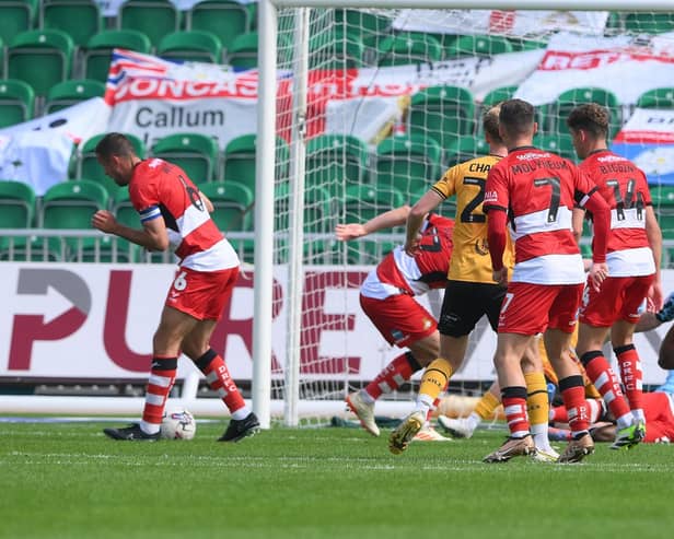 Doncaster Rovers' Joseph Olowu clearance rebounds of skipper Richard Wood for Newport's third goal.