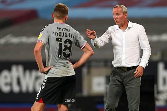 Charlton Athletic manager Lee Bowyer speaks with youngster Alfie Doughty