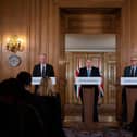 Chief Medical Officer Chris Whitty (L) and Chief Scientific Adviser Patrick Vallance (R) look on as Britain's Prime Minister Boris Johnson addresses a news conference (Photo by LEON NEAL/POOL/AFP via Getty Images)
