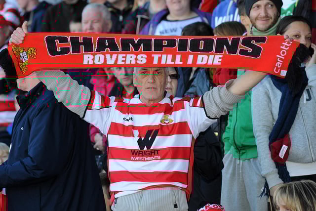 A Rovers fan celebrates at the presentation of the League One trophy
