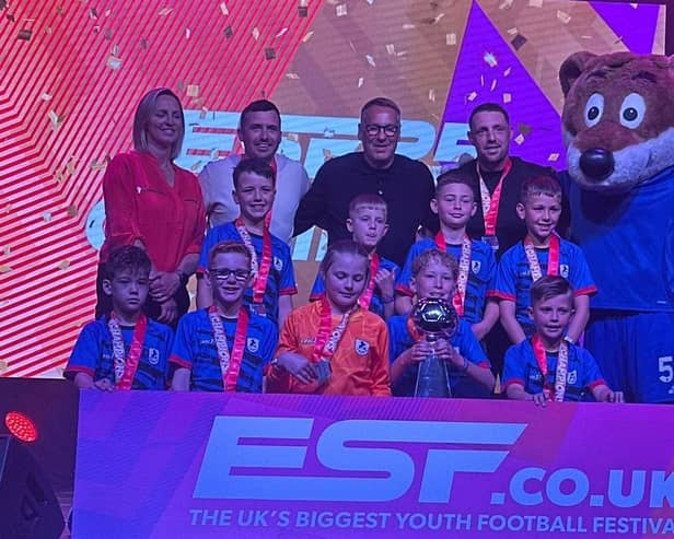 Barnby Dun Colts Under-9s receive their trophy from former Arsenal and England man Paul Merson.