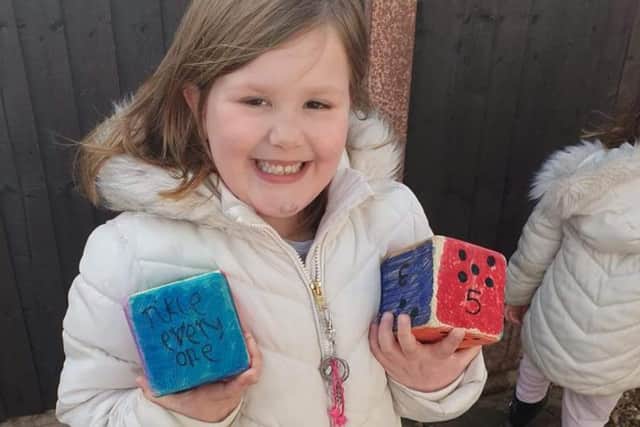 Nieva Webster with the cubes that her family have painted to create a game