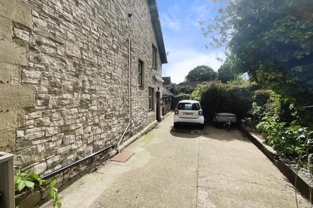 The driveway has parking for three cars.