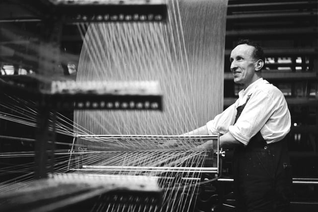 The warping process at the Blenkhorn, Richardson & Co. Ltd tweed factory, showing a worker at the machines, December 1965.
