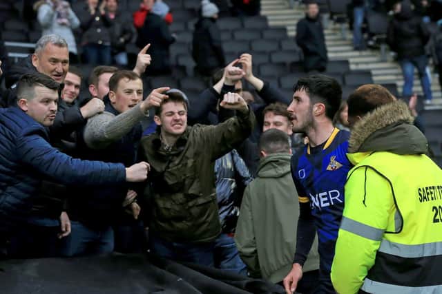 Doncaster Rovers defender Danny Amos celebrates with the fans