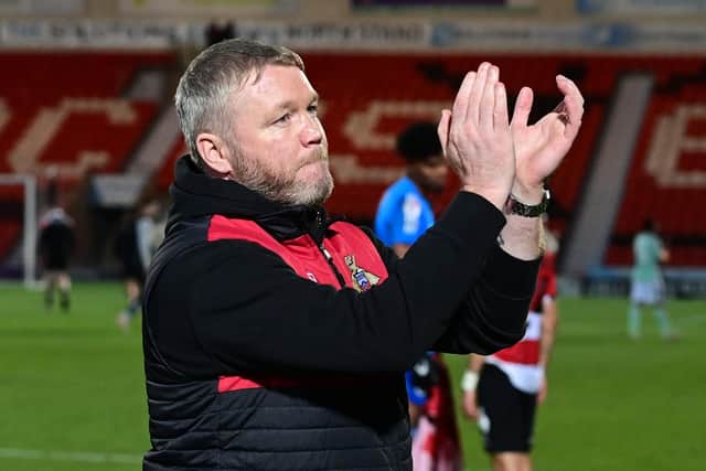 Doncaster Rovers manager Grant McCann applauds the fans at full time.