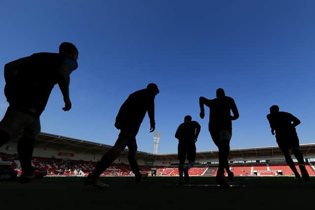 Players warm up at the Keepmoat