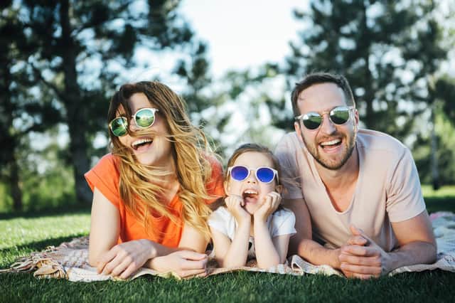 Happy family rest together in open air wearing their sunglasses
