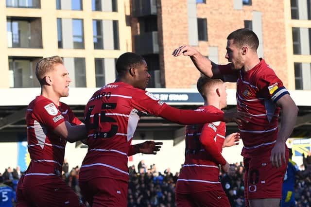 Tommy Rowe celebrates scoring with his teammates. Picture: Howard Roe/AHPIX LTD