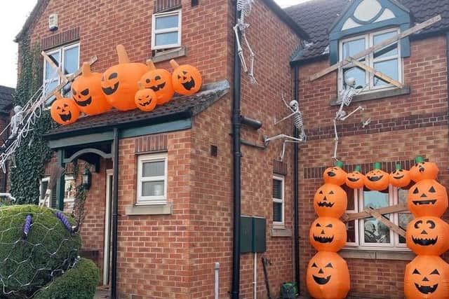 The house is decked out in pumpkins and skeletons.