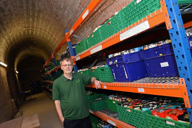 File picture shows Mark Snelson, the then volunteer manager, pictured in the crypt of the church where the tinned goods were once stored. Picture: Marie Caley NDFP Foodbank Christchurch MC 6