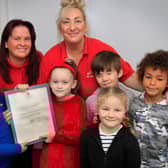 Pictured with their reply from Windsor Castle are (from left) Benjamin Monaghan, seven, Karen Boyer, Buttons OOSC Deputy Manager, Mya Hall, six, Tracy Robinson-Clegg, Buttons OOSC Manager, Baylin Mooney, nine, Molly Monaghan, five and Joseph Fayemi, seven. Picture: NDFP-21-12-21-ButtonsLetter 3-NMSY