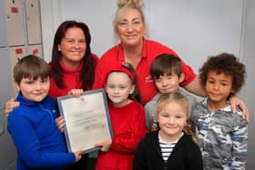 Pictured with their reply from Windsor Castle are (from left) Benjamin Monaghan, seven, Karen Boyer, Buttons OOSC Deputy Manager, Mya Hall, six, Tracy Robinson-Clegg, Buttons OOSC Manager, Baylin Mooney, nine, Molly Monaghan, five and Joseph Fayemi, seven. Picture: NDFP-21-12-21-ButtonsLetter 3-NMSY