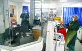 Medical staff wearing full PPE (personal protective equipment), including a face mask, long aprons, and gloves as a precautionary measure against COVID-19, work on an Intensive Care Unit (ICU) ward treating patients with COVID-19, at Frimley Park Hospital in Frimley, southwest England on May 22, 2020. - Britain's number of deaths "involving" the coronavirus has risen to 46,000, substantially higher than the 36,914 fatalities officially reported so far, according to a statistical update released Tuesday. (Photo by Steve Parsons / POOL / AFP) (Photo by STEVE PARSONS/POOL/AFP via Getty Images)
