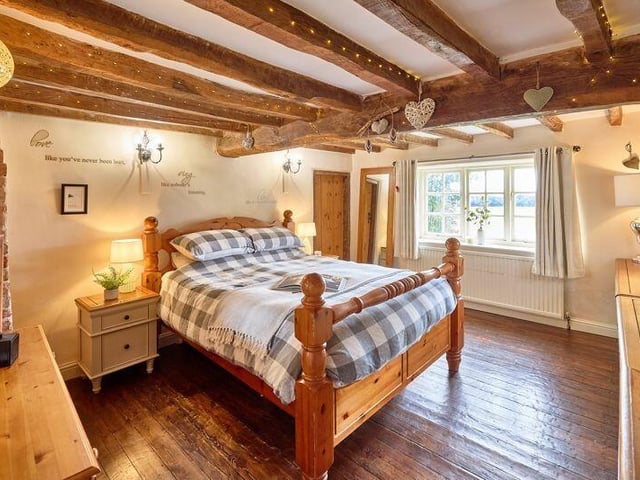 A rustic style double bedroom with extensive views.
