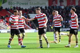 Harry Clifton (centre) takes the plaudits after scoring his first goal for Doncaster Rovers against Morecambe.