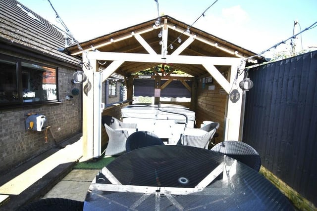 A seating patio, and a covered five-person hot tub, as outdoor facilities.