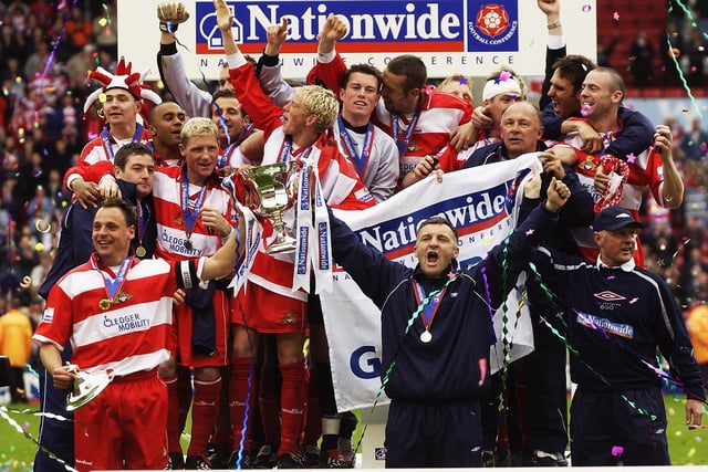 Doncaster players and staff celebrate promotion.