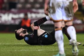 Doncaster's Ben Close clutches his knee after a challenge late on in the defeat at Bradford.