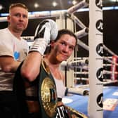 Terri Harper celebrates with the WBA and IBO world super-welterweight belts after defeating Hannah Rankin in Nottingham, England (photo by Nathan Stirk/Getty Images).