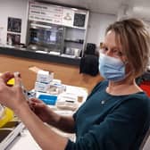 A doctor gets a vaccine ready at the Keepmoat Stadium vaccination centre