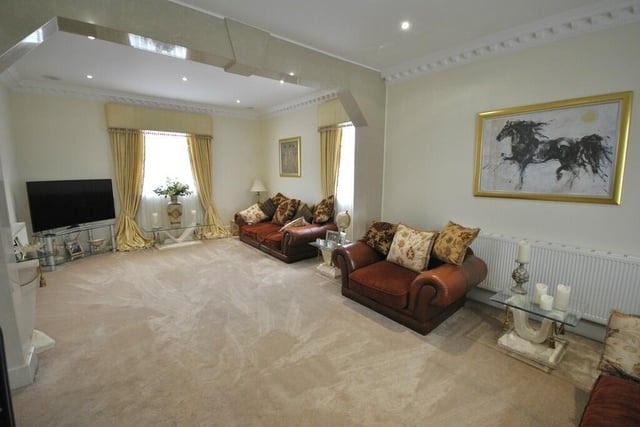The spacious sitting room, with decorative coving detail.
