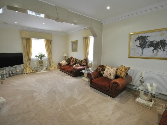 The spacious sitting room, with decorative coving detail.
