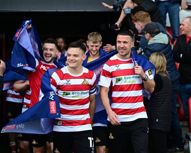 Owen Bailey and Richard Wood (right) lead the post-match lap of appreciation after Rovers' promotion against Bradford. Pic: Howard Roe.