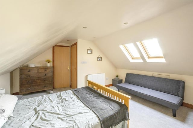 Bedroom Four - A double room with a double glazed roof window and a central heating radiator.